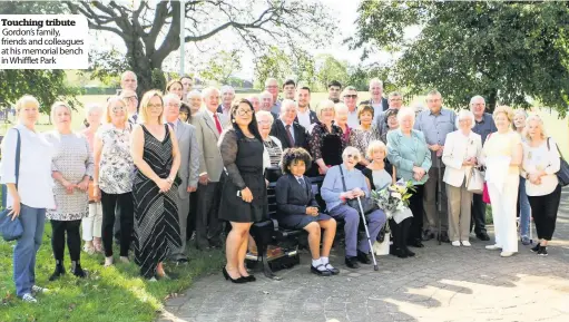  ??  ?? Touching tribute Gordon’s family, friends and colleagues at his memorial bench in Whifflet Park