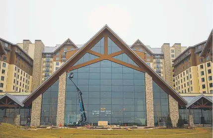  ?? Photos by Justin Edmonds, Special to The Denver Post ?? Workers attend to some final details on the outside of the Grand Lodge at the mammoth Gaylord Rockies Resort &amp; Conference Center in Aurora. The hotel complex, an $800 million project, will open Dec. 18.