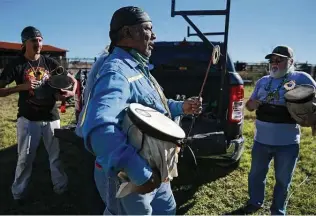  ?? Photos by Kin Man Hui / Staff photograph­er ?? From right, elders Fausto Cuevas, Edgar Bush and Jose Maestas prepare to play ceremonial drums as the Texas band of the Lipan Apache welcome a herd of buffalo to their land in Waelder.