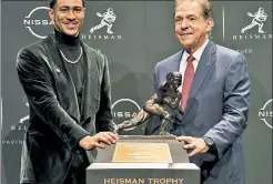  ?? AP ?? A FIRST: Bryce Young, with coach Nick Saban, became the first Alabama quarterbac­k to win the Heisman Trophy on Saturday night.