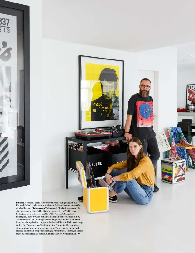  ??  ?? DJ area A portrait of Sid Vicious by Russell Young hangs above Houssein’s decks, where he and his wife Fabiana browse some of his vinyl collection Living room This space is filled with an assembly of iconic chairs. There’s the ‘Kilin’ armchair from 1973 by Sergio Rodrigues for Oca Industries, the 1960s ‘Tonico’ chair, also by Rodrigues, ‘Zeca’ by José Zanine Caldas and ‘Fauteuil de Salon’ by Jean Prouvé for Vitra. The geometric rug is Moroccan and the floor lamp is a vintage industrial piece. At the middle of it all sit two vintage tables; the ‘Contract’ by Charles and Ray Eames for Vitra, and the other made of jacaranda wood and cane. The artworks on the wall include a diamond-shaped painting by Raymundo Collares, as well as those by Frank Stella, Frank Roth and Maurício Nogueira Lima