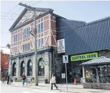  ?? PHOTO BY DARREN STONE, TIMES COLONIST ?? Capital Iron’s landmark store on Store Street is part of a land and building sale, indicated on map.