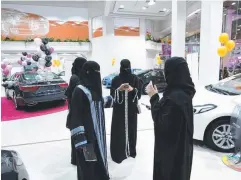  ?? Picture: AFP ?? KICKING TYRES: Saudi women tour a car showroom for women in the Saudi Red Sea port city of Jeddah. The showroom offers a wide selection of vehicles and is staffed by women only.