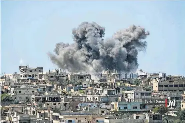  ?? [NABAA MEDIA VIA AP] ?? Smoke rises over buildings that were hit Thursday by Syrian government forces bombardmen­t in Daraa province, southern Syria.
