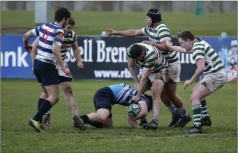  ??  ?? Michael Doyle puts down Alan Francis during the Greystones v Blackrock clash.