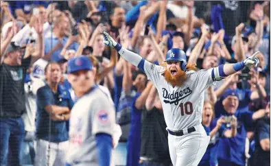  ?? ROBERT HANASHIRO / USA TODAY SPORTS ?? Justin Turner of the Los Angeles Dodgers celebrates his three-run homer against the Chicago Cubs in the ninth inning of Game 2 in the National League Championsh­ip Series at Dodger Stadium on Sunday.