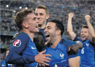  ?? BERTRAND LANGLOIS/AFP/GETTY IMAGES ?? Antoine Griezmann, left, Lucas Digne, centre, and Adil Rami celebrate France’s 2-0 Euro 2016 semifinal win over Germany on Thursday.