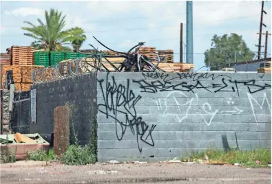  ??  ?? A defaced wall near 16th and Thomas streets is a Phoenix graffiti hot spot. The city spends about $2 million a year to clean up graffiti.