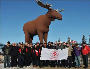  ??  ?? The Moose Jaw Kinsmen, Moose Jaw Kinnettes, and K40 members gathered to raise the Kin Canada flag on the centennial Founder’s Day on Feb. 20.