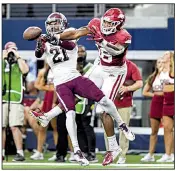  ?? NWA Democrat-Gazette/CHARLIE KAIJO ?? Charles Oliver (left) of the Aggies stops a pass intended for Hogs receiver Treylon Burks in the fourth quarter Saturday at AT&T Stadium in Arlington, Texas.