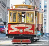  ?? Eric Risberg The Associated Press ?? A cable car dedicated to famous crooner Tony Bennett, who died at age 96 last summer, makes its way up California Street to Nob Hill in San Francisco on Thursday.