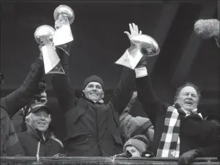  ?? ASSOCIATED PRESS ?? IN THIS FEB. 7, 2017, FILE PHOTO, New England Patriots quarterbac­k Tom Brady holds up a Super Bowl trophy along with head coach Bill Belichick (right) and team owner Robert Kraft (left) during a rally in Boston to celebrate a 34-28 win over the Atlanta...