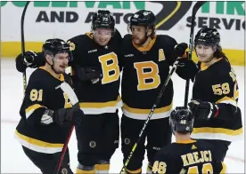  ?? MICHAEL DWYER — THE ASSOCIATED PRESS ?? The Bruins’ David Pastrnak, center, celebrates his goal with Dmitry Orlov, left, Charlie Mcavoy, second from left, Tyler Bertuzzi, far right, and David Krejci during the third period of Saturday’s game in Boston against the Rangers.