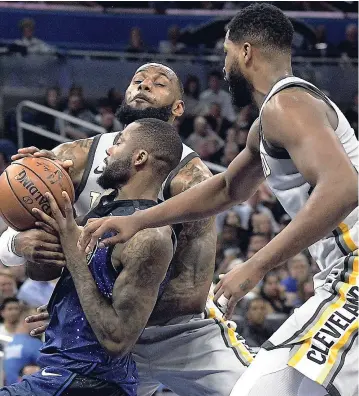  ??  ?? Cleveland Cavaliers forward LeBron James (rear) and centre Tristan Thompson defend against Orlando Magic forward Jonathon Simmons during the second half of their NBA game on Tuesday in Orlando, Florida. The Magic won 116-98.