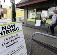  ?? ELAINE THOMPSON — THE ASSOCIATED PRESS FILE ?? A reader board advertises a job opening for a remodeling company, in Seattle in this photo from last month. U.S. companies added nearly 2.4 million jobs in June, according to a private survey, a large gain that still leaves the job market far below its pre-pandemic levels.