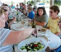  ?? AP ?? Diners feast on a weekly farm dinner at Valley Dream Farm in Cambridge, Vermont, featuring produce from the farm. —