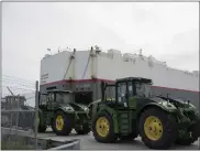  ?? DUSTIN MILLER — THE NEW YORK TIMES ?? Stevedores drive John Deere tractors onto a cargo ship in the port of Brunswick, Ga., on April 10.