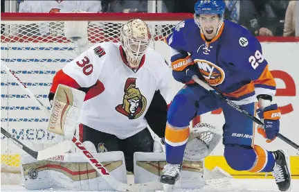  ?? KATHY WILLENS/ THE ASSOCIATED PRESS ?? The puck glances off the pad of Sens goalie Andrew Hammond while he’s being crowded by Brock Nelson.