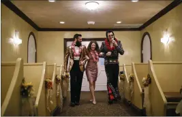  ?? JOHN LOCHER — THE ASSOCIATED PRESS FILE ?? Elvis impersonat­or Brendan Paul, right, walks down the aisle during a wedding ceremony for Katie Salvatore, center, and Eric Wheeler at the Graceland Wedding Chapel in Las Vegas.