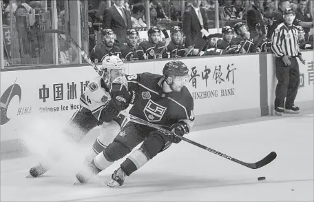  ?? Chandan Khanna AFP/Getty Images ?? KINGS DEFENSEMAN Oscar Fantenberg controls the puck during Thursday’s preseason victory over the Vancouver Canucks in China.