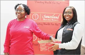  ?? (Courtesy pics) ?? SBS Business Analyst Nonhlanhla Kazembe draws a winner while Hlengiwe Dube of Compliance assists.