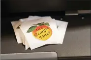  ?? BEN GRAY - THE ASSOCIATED PRESS ?? A stack of stickers sits atop the ballot scanner during the mid-term election Tuesday, Nov. 8, at Lawrencevi­lle Road United Methodist Church in Tucker, Ga.