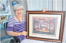  ?? SHARON MONTGOMERY-DUPE/CAPE BRETON POST ?? Wendy Littlejohn of New Waterford holds a painting of the Savoy Theatre in Glace Bay, a gift from the theatre staff as a thank you for her donation of a van.