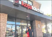  ?? SARAH TAN ?? Wife-and-husband team Carien and Will Kwok stand outside the Asian fusion Koja Kitchen in Alameda Landing. The restaurant chain specialize­s in rice bun burgers with Korean barbecue-style meat and Korean and Japanese rice bowls.