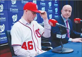  ?? Associated Press photo ?? Washington Nationals President of Baseball Operations and General Manager Mike Rizzo, right, announces the signing of pitcher Patrick Corbin, left, during a news conference at Nationals Park in Washington, Friday.