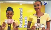  ?? XINHUA ?? Staff of National Bank in Nairobi hold yuan and shilling notes, to signal launch of transactio­ns in the Chinese currency.