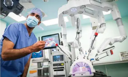  ??  ?? Scotland’s health secretary, Humza Yousaf, watches a surgical robot at work at Glasgow Royal Infirmary. Photograph: Jane Barlow/PA