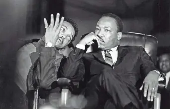  ?? KEN ROSS / MEMPHIS PRESS-SCIMITAR ?? Martin Luther King Jr., seated with aide Jesse Jackson, arrives at the Mason Temple in Memphis on April 3, 1968. Various activities are planned to honor the slain civil rights leader in Memphis on MLK Day this year.