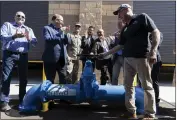  ?? PHOTO BY ANDREW FOULK ?? Dignitarie­s applaud and turn a ceremonial water valve during the grand opening for Eastern Municipal Water District’s new Perris II Groundwate­r Desalinati­on Facility in Menifee on June 23.