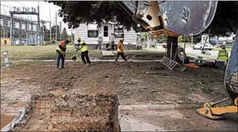  ?? PAUL SANCYA/AP ?? Workers backfill a hole used in replacing lead pipe with copper water supply lines to a home in Flint, Mich., in July. Flint is removing lead service lines but not as fast as promised.