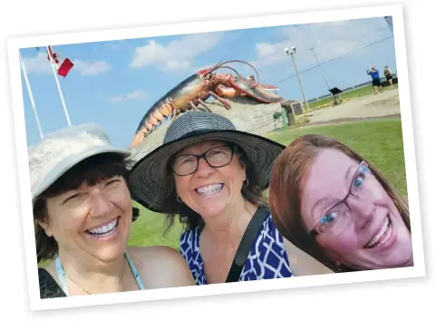  ??  ?? Left: The lighthouse in Rustico, P.E.I. Above: Denise (left) and Debbie photo-bombed by “Wendi” in Shediac, N.B.!