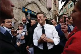  ?? ?? Centrist candidate and French President Emmanuel Macron reacts as he meets residents after a campaign rally Friday in Figeac, southweste­rn France.