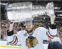  ?? ELISE AMENDOLA THE ASSOCIATED PRESS FILE PHOTO ?? Chicago defenceman Brent Seabrook hoists the Stanley Cup after the Blackhawks beat the Bruins 3-2 in the Stanley Cup final in Boston in 2013. Seabrook played on three NHL champions.