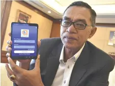  ?? Bernama photo ?? Rosol shows the Ez ADU app on a smartphone screen. —