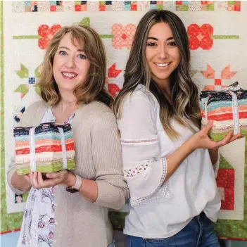  ??  ?? Mother and daughter, united in their work, holding bundles of their Harper’s Garden fabric collection. Chelsi can be found online at www.chelsistra­tton.wordpress.com.