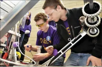  ?? MIKE MCMAHON — THE RECORD ?? Danny Lehane and Dan Baker of the Ballston Spa High School Team 3044 work out adjustment­s on their robot on Thursday, one day prior to the New York Tech Valley Regional FIRST Robotics Competitio­n. More than 1,000 high school students, along with...