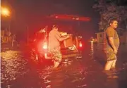  ?? CHIP SOMODEVILL­A/GETTY IMAGES ?? Men pack their belongings after evacuating their house Thursday after the Neuse River went over its banks and flooded their street in New Bern, N.C.