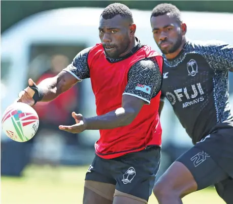  ?? Photo: World Rugby ?? Fiji Airways Fijian 7s forwards Asaeli Tuivuaka delivers a pass while Sevuloni Mocenacagi closes in during training in London on May 19, 2019.