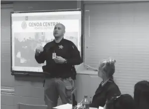  ?? Staff photo by Jennifer Middleton ?? ■ Darrell Klink, the school resource officer at Genoa Central School District, speaks to the district‘s board of directors Monday about how he has worked to increase school safety. Genoa Superinten­dent Angela Bryant is looking into several...