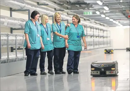  ??  ?? MOVING: South Glasgow University Hospital staff Patricia Murphy, Louise Nesbitt, Mandy Keenan and Tracey Neish watch the robots. Picture: Colin Mearns