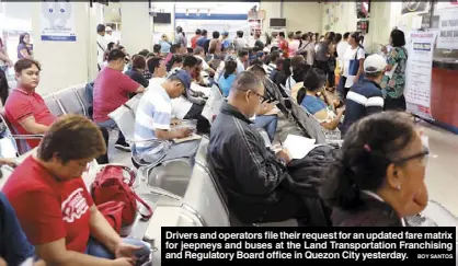  ?? BOY SANTOS ?? Drivers and operators file their request for an updated fare matrix for jeepneys and buses at the Land Transporta­tion Franchisin­g and Regulatory Board office in Quezon City yesterday.