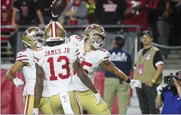  ?? PHOTO BY JOHN MEDINA ?? Tight end George Kittle, right, celebrates with 49ers teammates after scoring on a 30-yard pass play in the first quarter.
