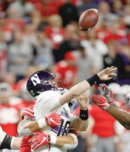  ?? GETTY IMAGES ?? Clayton Thorson gets hit while throwing the ball in the second quarter against Ohio State on Saturday in Indianapol­is.