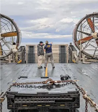  ?? Associated Press ?? In this image provided by the FBI, agents stand aboard a vessel as they search for possible material from high altitude balloon that was shot down off the coast of Myrtle Beach, S.C.