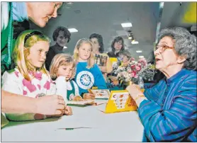  ?? Vern Fisher The Associated Press file ?? Beverly Cleary signs books in April 1998 at the Monterey Bay Book Festival in Monterey, Calif. Harpercoll­ins announced Friday she had died at the age of 104.