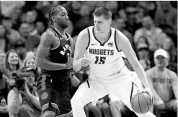  ?? MATTHEW STOCKMAN/GETTY ?? Nuggets big man Nikola Jokic, going against Toronto’s Kawhi Leonard on Sunday, is averaging 21.7 points, 11 rebounds and 8.6 assists per game this month.